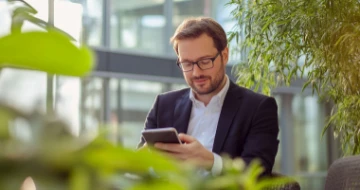 Mann mit Handy arbeitet mobil